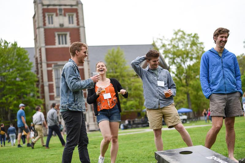 Group of people laughing on campus